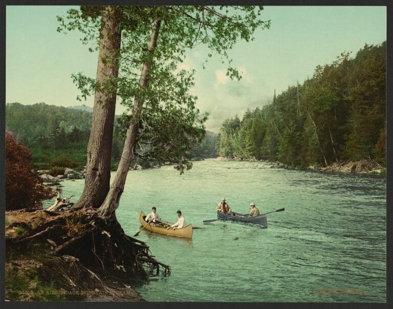 An Adirondak with people fishing in canoes